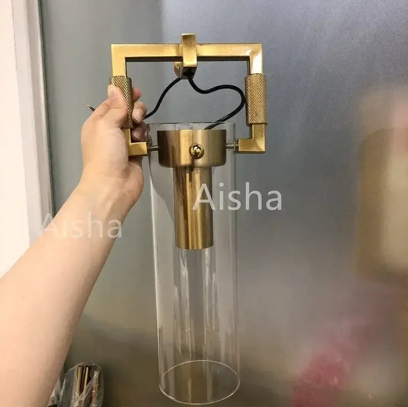 Gold Glass Wall Sconce with Clear Shade Design
